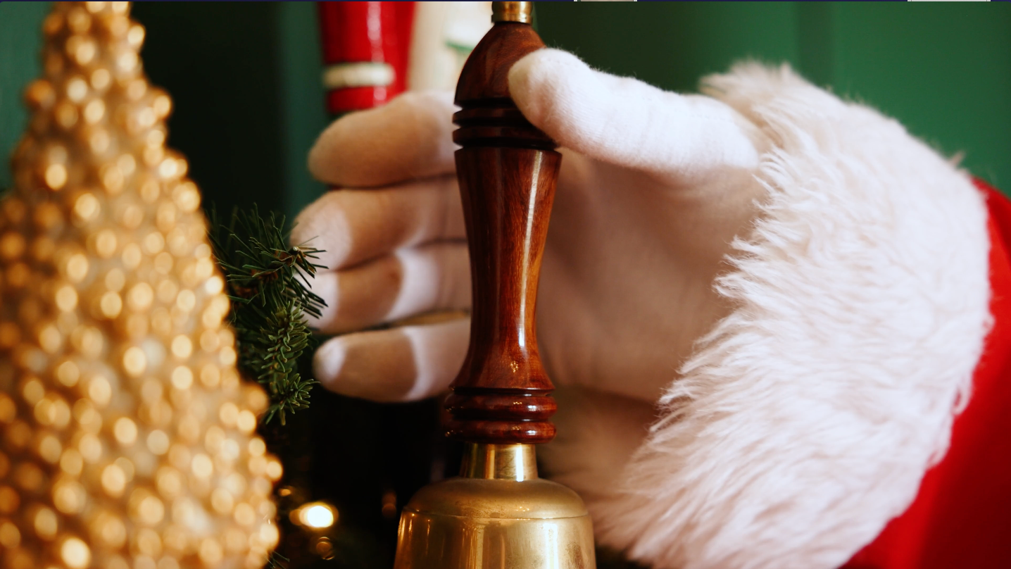 Photo of Santa Claus receiving his bell inside his cottage at Chandlers Hill Christmas Tree Farm