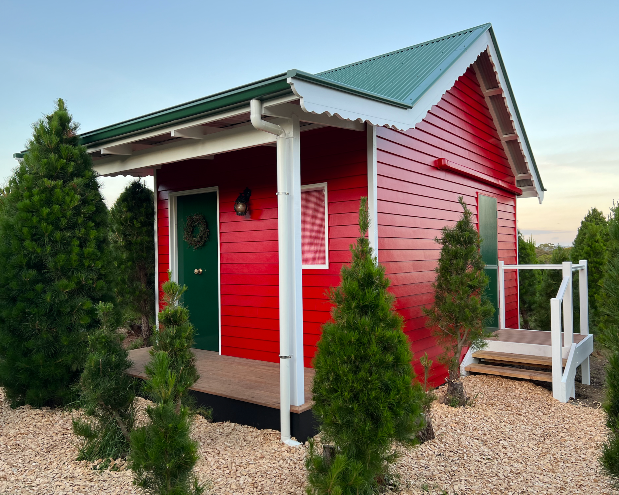 Photo of Santa’s red cottage nestled in the forest at Chandlers Hill Christmas Tree Farm